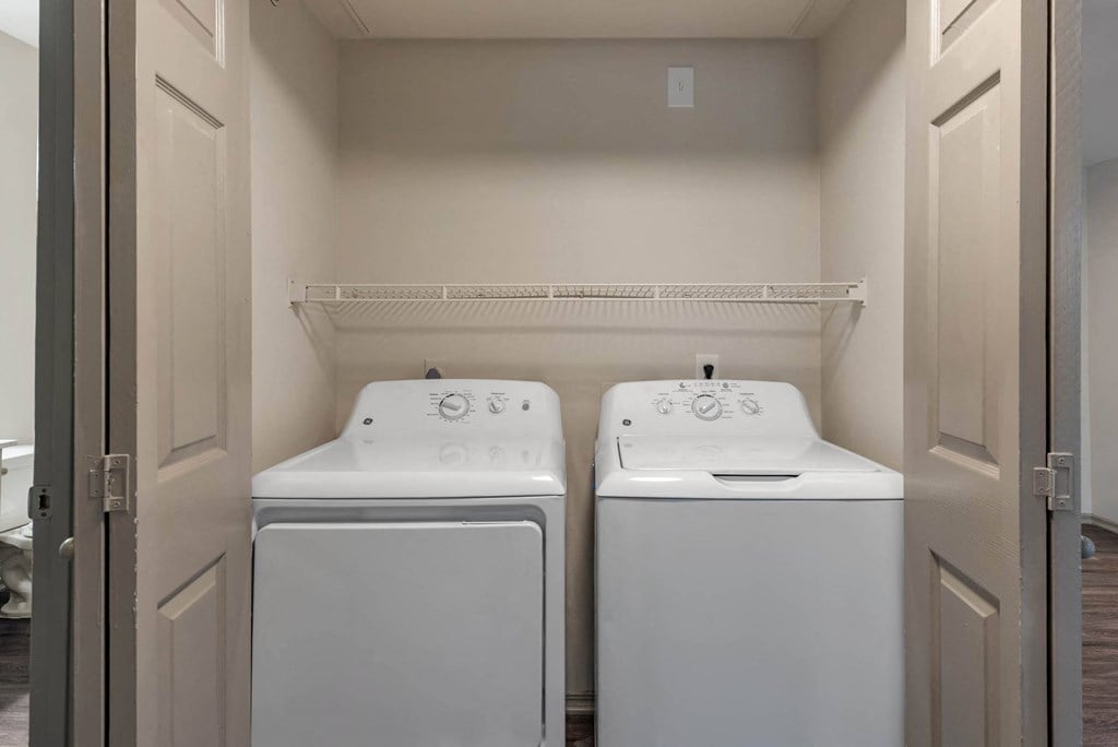 a washer and dryer in a laundry room with two white machines
